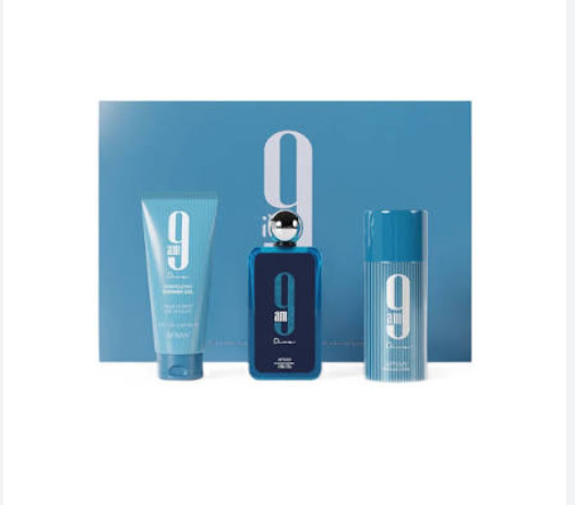 A men's fragrance gift set featuring a blue rectangular perfume bottle with a large white '9' logo, a light blue body wash tube, and a light blue deodorant canister, all arranged in front of a matching blue box on a white background.