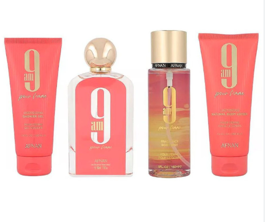 A 4-piece Annan 9am Jolie Femme fragrance set on a white background, including a coral pink body wash tube, a clear glass perfume bottle with a gold cap, a clear glass body spray bottle with a gold cap showing a sunset gradient, and a coral pink body lotion tube.