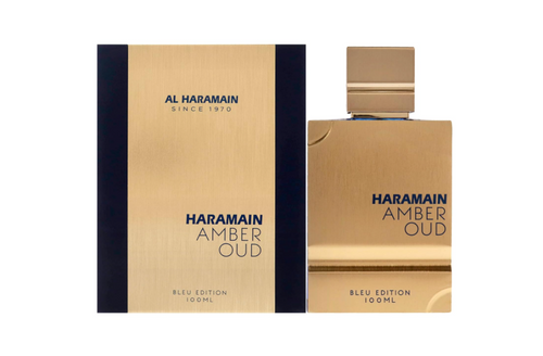 Al Haramain Amber Oud Bleu Eau de Toilette bottle and packaging box, featuring a brushed gold metallic design with dark navy blue side panels and text, on a solid white background.