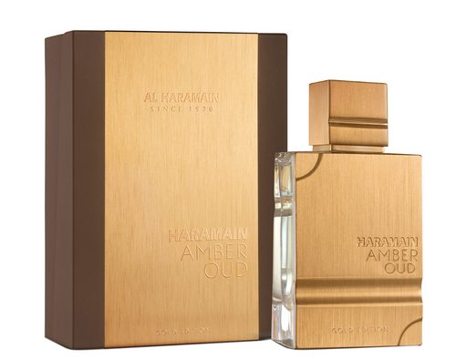 Al Harawain Amber Oud cologne set featuring a rectangular clear glass bottle with a brushed gold cap and front panel, alongside its matching brown and gold outer box. The brand name 'AL HARAWAIN' and product name 'HARAWAIN AMBER OUD' are embossed on both items.Al Haramain Amber Oud Gold Edition Unisex Eau de Parfum 100ml brushed gold rectangular bottle with matching gold and brown gift box - Authentic Perfume Store UPC 6291100130122