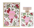 A perfume bottle and its matching box, both decorated with a colorful floral pattern featuring red, pink, and white flowers with green leaves on a white background. The box has a gold border and a pink circular label reading 'LUMIÈRE Dubai', and the bottle has a matching pink label and a pale pink cap.