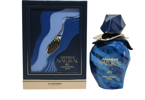 Al Haramain Natural Iris Extrait de Parfum shown with its outer packaging box. The perfume bottle is a deep blue with a faceted cap and gold lettering, while the box features an abstract blue and gold wave design.