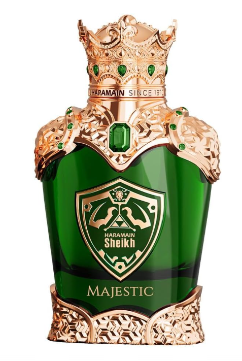 Haramain Sheikh Majestic perfume bottle, featuring a rich green glass body adorned with an ornate gold crown, shoulders, and base, embellished with green gemstones. The front displays a gold shield logo with two crossed swords and the text 'HARAMAIN SHEIKH'.