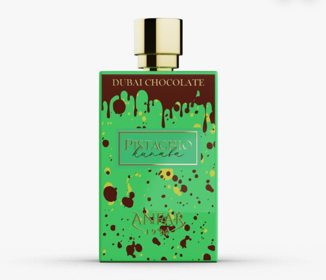 A rectangular perfume bottle labeled 'DUBAI CHOCOLATE' and 'PISTACHIO kunafa' by ANFAR, featuring a bright green body with chocolate-brown splatter and drip details, topped with a shiny gold cap, on a light gray background.