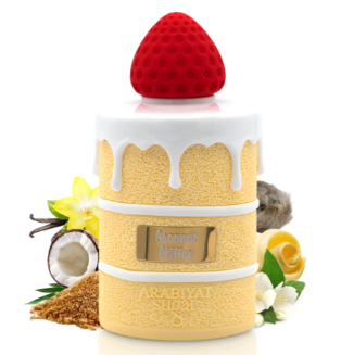 A dessert-shaped coconut oil diffuser with a red strawberry on top, white frosting, and yellow coconut cream layers, surrounded by coconut, vanilla, and yellow flowers on a white background.