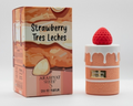 A perfume bottle shaped like a strawberry-topped pastry next to its illustrated retail box. The packaging reads 'Strawberry Tres Leches' and 'ARABIYAT SUCRE', with peach, cream, and red-orange artwork.