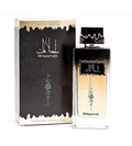 A bottle of Ahlaamak perfume next to its black and gold packaging box, featuring Arabic calligraphy and a gradient from black to gold.