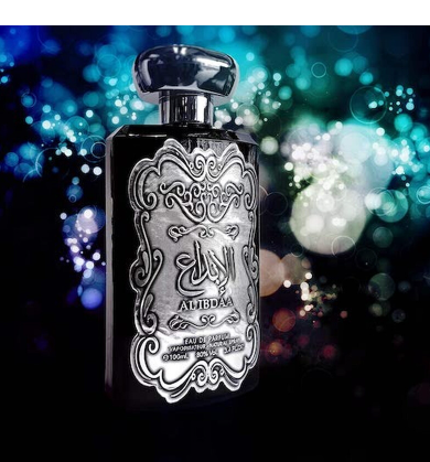 A decorative perfume bottle with ornate silver Arabic calligraphy and the word 'ALIBBAA' on a black bottle, set against a dark background with colorful bokeh lights.