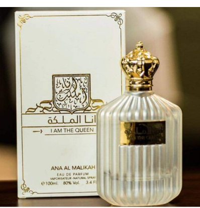 Ana Al Malikah Eau de Parfum bottle with a ribbed clear glass body and ornate gold cap, shown next to its white and gold packaging box.