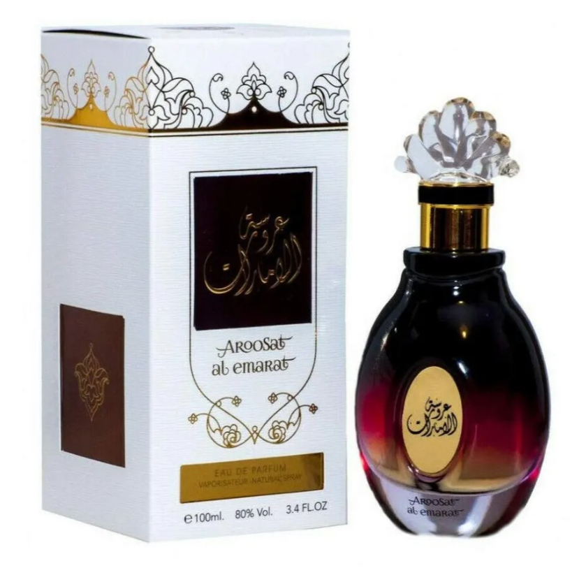 Aroosat al emarat Eau de Parfum bottle next to its white and gold packaging box, featuring elegant Arabic calligraphy.