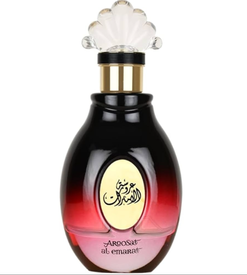 A bottle of Aroasat al emarat perfume with a glossy black-to-red gradient body, a gold neck accent, and a clear scalloped cap on a white background.