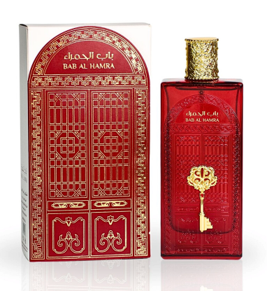 A red rectangular perfume bottle with a gold key emblem and a gold cap stands beside its matching red and gold box, labeled BAB AL HAMRA, on a clean white background.