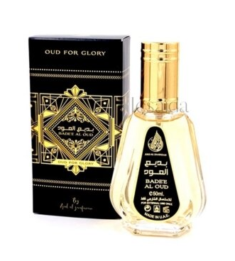 A bottle of Oud For Glory Badee Al Oud perfume next to its black and gold packaging box, on a white background.