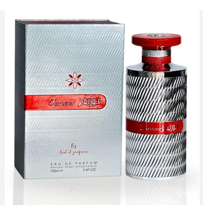 A 100ml bottle of By Ariel al zafaran Jazira Eau de Parfum next to its silver packaging box, featuring a textured silver design with a red band and red cap.