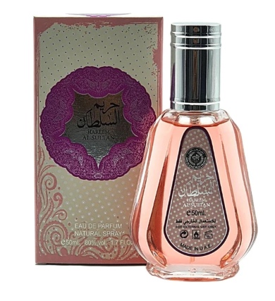 A bottle of Al-Sufiyan Eau de Parfum next to its decorative pink and gold packaging box, featuring Arabic text and a purple circular emblem.