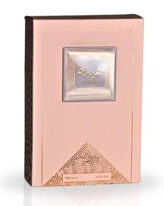 A rectangular perfume box in a pale blush pink color with a metallic silver label in the center and Arabic script, shown on a white background with a faint reflection.