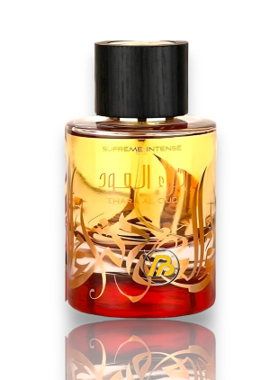 A bottle of Ritz perfume with a black cap, featuring a golden and red gradient body with gold swirls and the brand logo, set against a white background with a reflection below.
