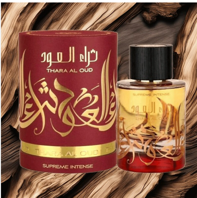 Thara Al Oud Supreme Intense perfume bottle and its matching cylindrical box, both in deep red and gold with Arabic calligraphy, set against a rustic wood background.