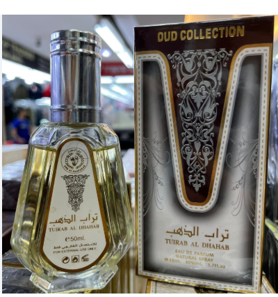 A bottle and retail box of Tuirab Al Dhihab Eau de Parfum from the Oud Collection, displayed on a store shelf.
