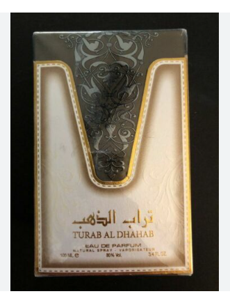 Turab Al Dhahab Eau de Parfum 100ml box packaging, featuring a metallic silver and gold ornate design with Arabic and English text on a black background.
