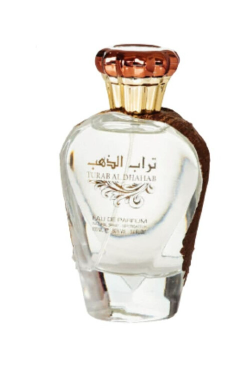 A clear glass perfume bottle with a metallic rose gold cap and a brown textured side accent, labeled 'Tubaid Al Dhahir' on a white background.