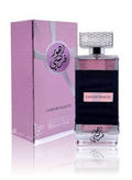 Zahoor France perfume bottle and its pink packaging box, featuring Arabic calligraphy and a textured design on a reflective white surface.