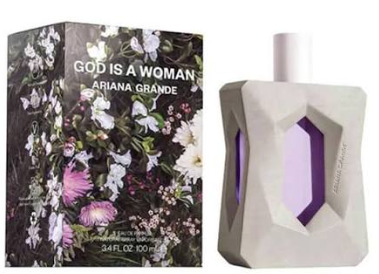Ariana Grande 'God Is A Woman' Eau de Parfum bottle and packaging box. The bottle is a light gray geometric shape with a purple hexagonal cutout revealing the purple liquid inside.
