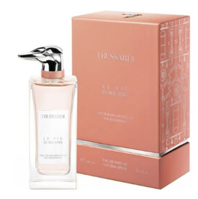A bottle of Trespassio Le Sier Di Milano Eau de Parfum next to its peach-colored packaging box, set against a plain white background.
