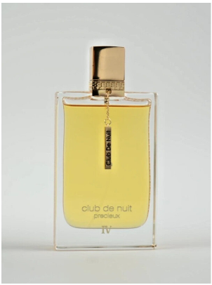 A rectangular glass perfume bottle with pale yellow liquid, a gold cap, and a hanging label reading 'Club De Nuit Precieux', photographed against a light gray background.