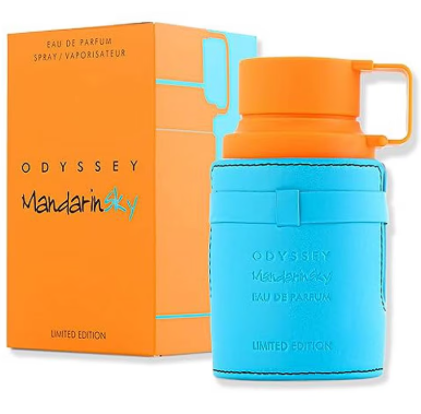 Odyssey Mandarin Sky Eau de Parfum Limited Edition, featuring a bright blue cylindrical bottle with an orange cap and handle, standing in front of its orange packaging box.