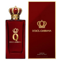 Dolce & Gabbana Q Parfum bottle in deep red glass with a gold crown cap, shown next to its matching red and gold outer box on a white background.