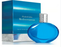 Elizabeth Arden Mediterranean Eau de Parfum bottle and packaging box. The bottle is a vibrant blue glass with a textured silver cap, positioned in front of its matching blue box with silver accents.