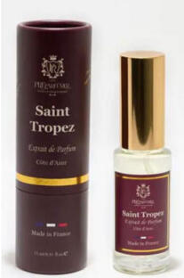 A bottle of Saint Tropez Eau de Parfum next to its dark brown cylindrical packaging box, featuring a gold cap and gold accents.