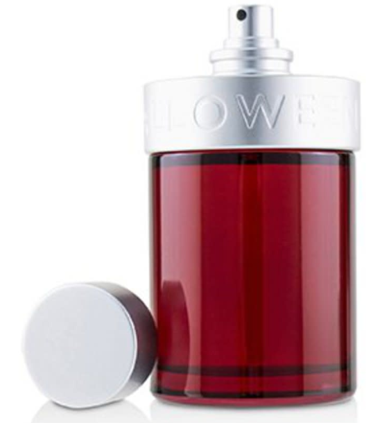A red glass perfume bottle with a silver spray top and a separate silver cap placed beside it on a white background.