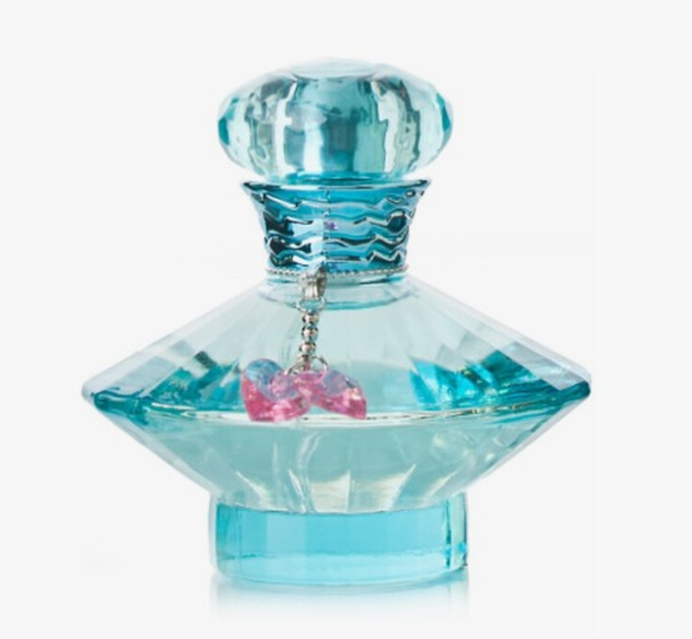A faceted light blue glass perfume bottle with a matching round cap and a dangling pink heart charm, shown on a plain white background.