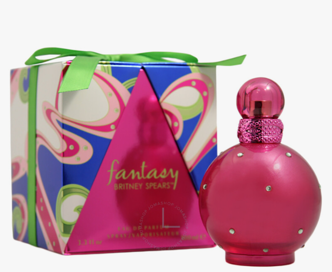 Britney Spears 'Fantasy' Eau de Parfum bottle in metallic pink next to its colorful gift box with a green ribbon, on a white background.