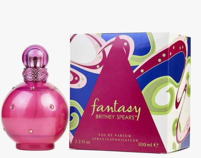 Britney Spears 'Fantasy' Eau de Parfum bottle and packaging box. The bottle is a glossy, rounded magenta pink with a textured glittery neck and small rhinestone accents.