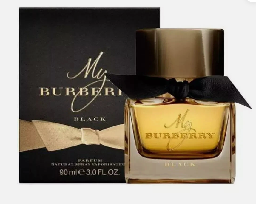 Burberry My Burberry Black perfume bottle with golden liquid and a black ribbon bow, shown next to its black packaging box with gold lettering.
