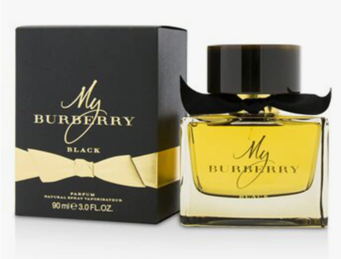 Burberry My Burberry Black perfume bottle with yellow liquid and a black mustache-shaped cap, shown next to its black and gold box.