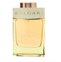Bvlgari Man Terrae Essence cologne bottle with a pale gold liquid, a light beige marble-look cap, and a metallic rose gold cap, on a white background.