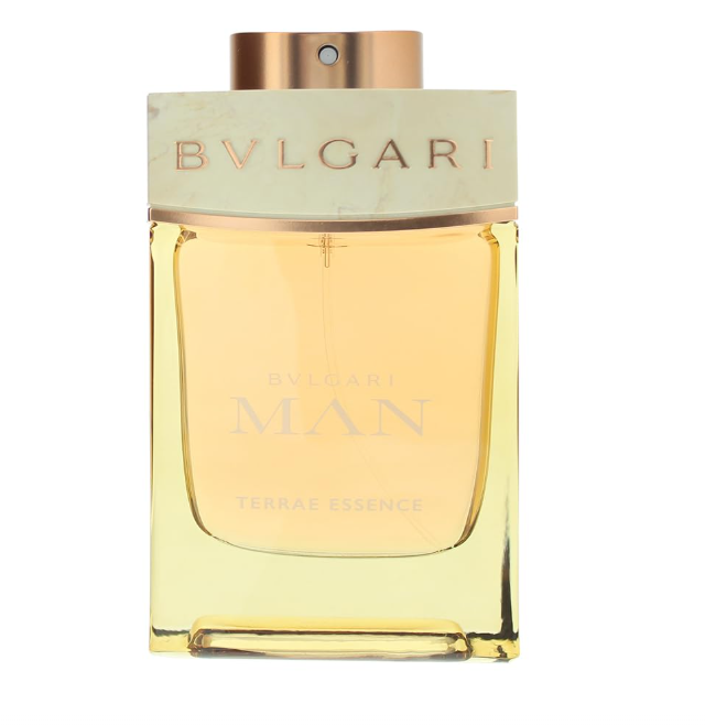 Bvlgari Man Terrae Essence cologne bottle with a pale gold liquid, a light beige marble-look cap, and a metallic rose gold cap, on a white background.