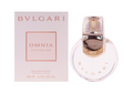 Bvlgari Omnia Crystalline Eau de Toilette shown with its pale pink packaging box and a clear round perfume bottle with a metallic gold cap on a white background.