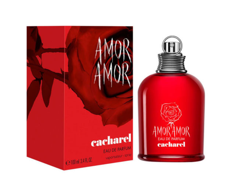 A 100ml bottle of Cacharel Amor Amor Eau de Parfum next to its red packaging box, featuring a red rose design and white lettering on a white background.