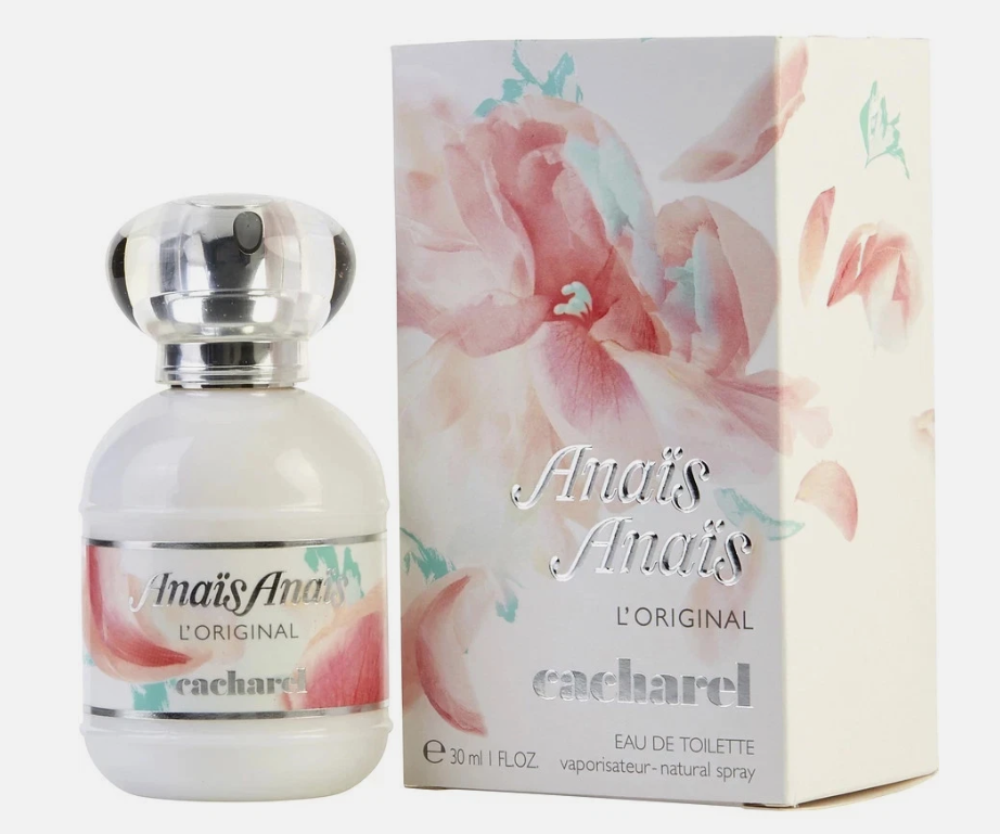 A bottle of Cacharel Amais-Amais L'Original Eau de Toilette next to its floral-patterned packaging box, featuring soft pink and blue watercolor flowers on a white background.