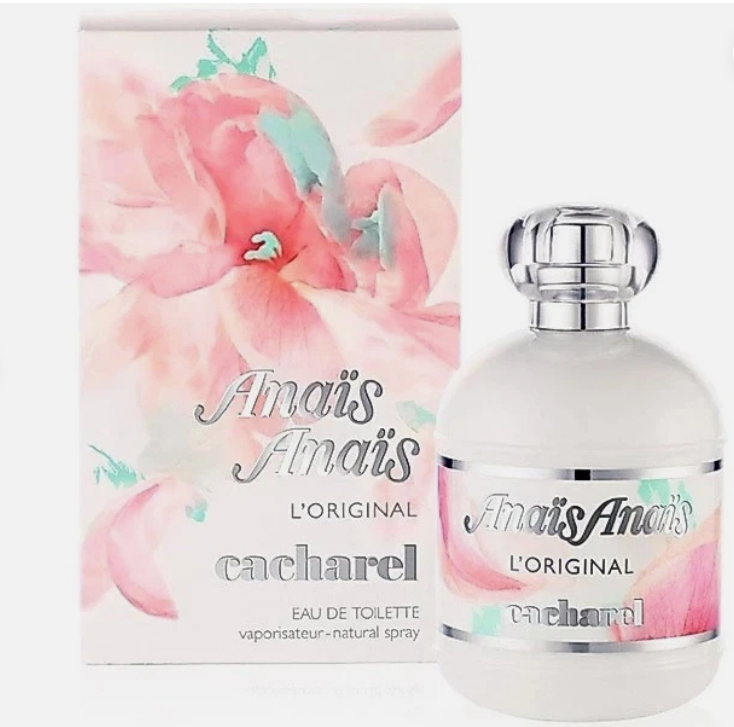A bottle of Cacharel Amais Amais L'Original Eau de Toilette next to its matching floral box. The packaging features a watercolor pink flower design with mint green accents, and the bottle is frosted white with a silver cap and label.