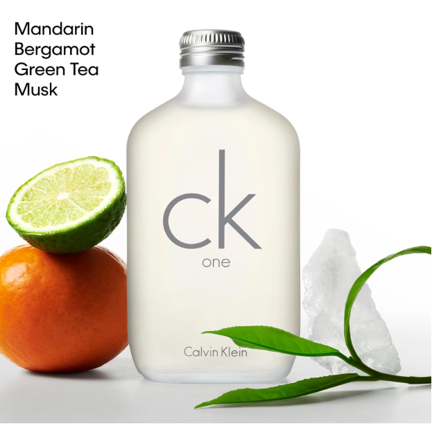 A frosted glass bottle of Calvin Klein One fragrance with a silver cap, shown on a white background with citrus fruit, green tea leaves, and ice crystals. Text in the upper left reads 'Mandarin Bergamot Green Tea Musk'.