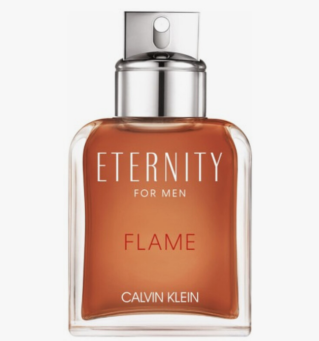 Calvin Klein Eternity For Men Flame fragrance bottle, featuring a clear glass container filled with a warm amber-brown liquid and a metallic silver spray cap, set against a plain white background.