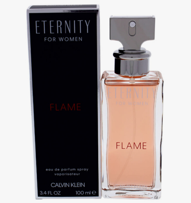 Calvin Klein Eternity For Women Flame Eau de Parfum spray bottle with its black packaging box, featuring a peach-colored liquid and silver cap on a white background.
