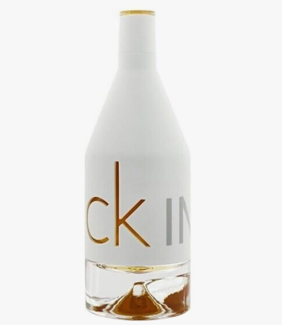A bottle of Calvin Klein CK IN2U fragrance with a white label, gold lettering, and a clear glass base showing amber liquid inside, set against a plain white background.