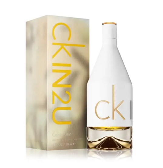 Calvin Klein CK IN2U perfume bottle and its matching packaging box, featuring a white bottle with gold 'ck' lettering and a gold-toned liquid base, next to a beige box with large gold 'ckin2u' text.